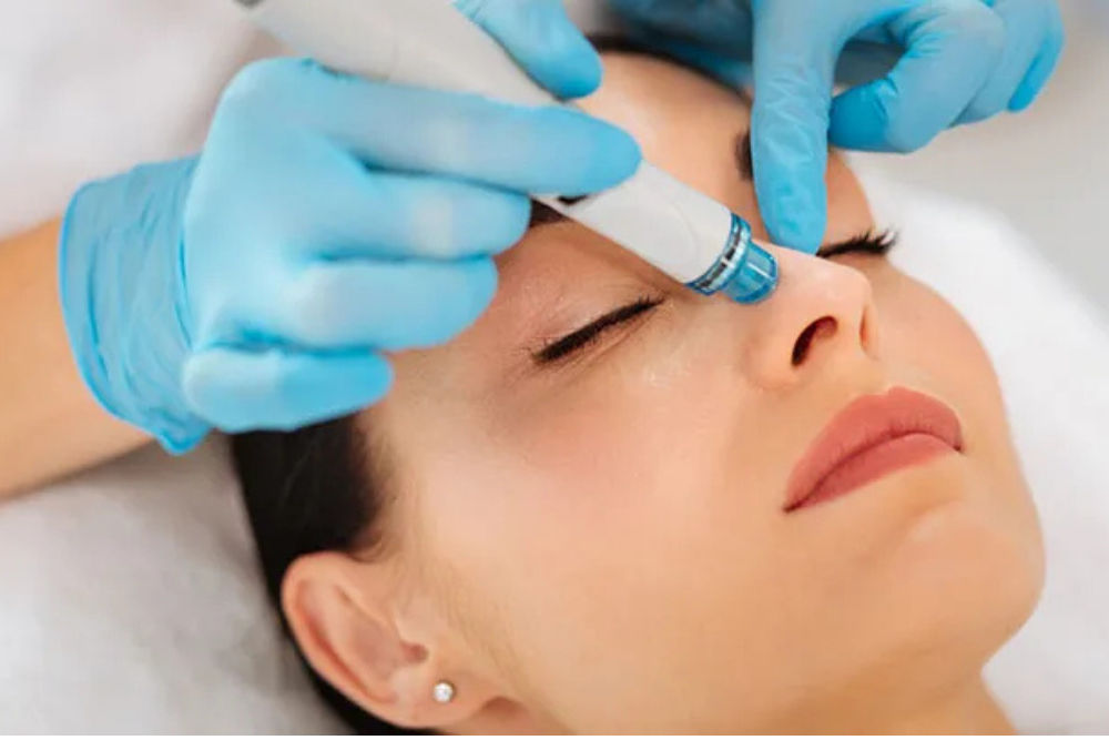 Esthetician performing a facial skin treatment on a client